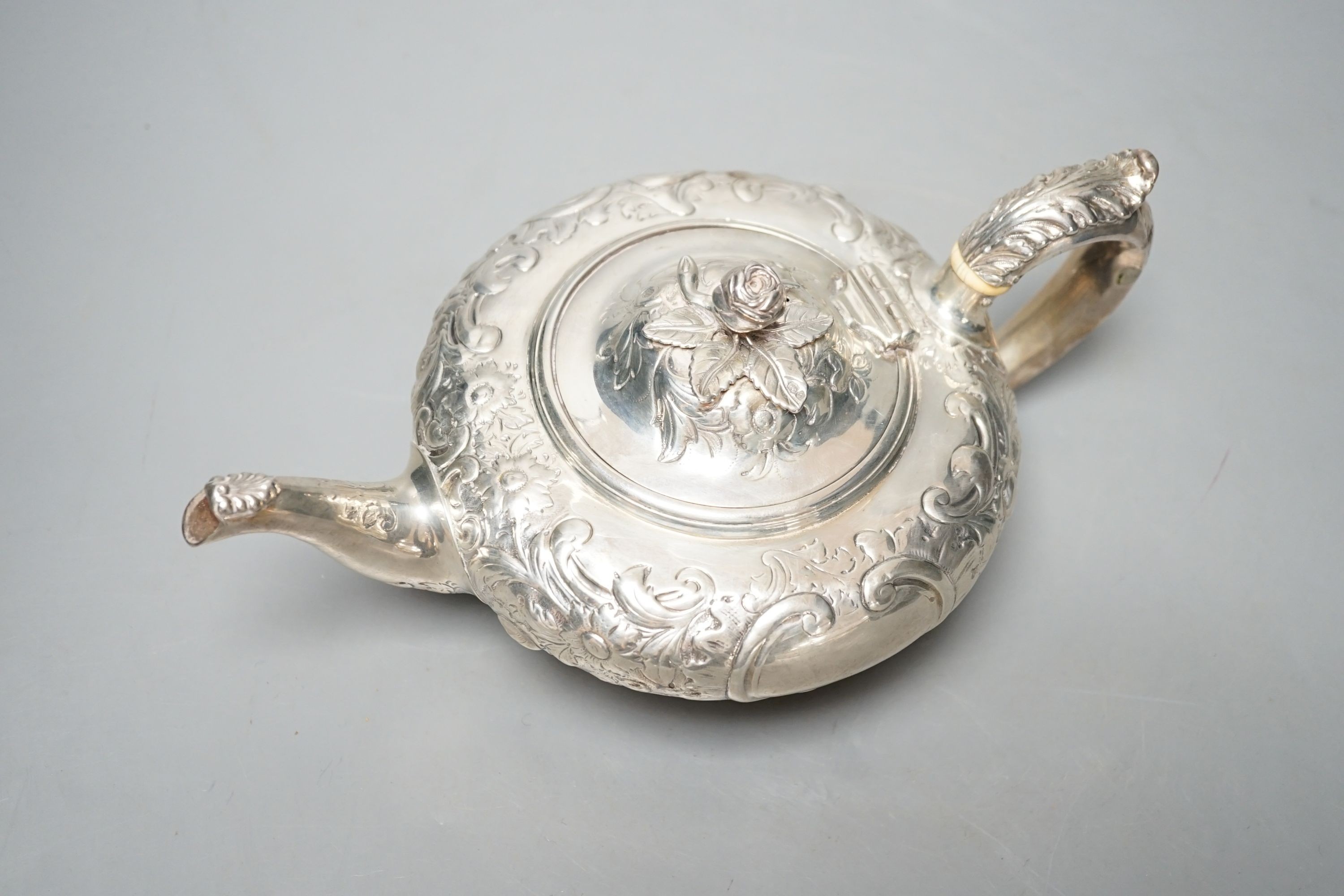 A Victorian embossed silver teapot, Walter Morrise, London, 1842, gross 15.5oz.